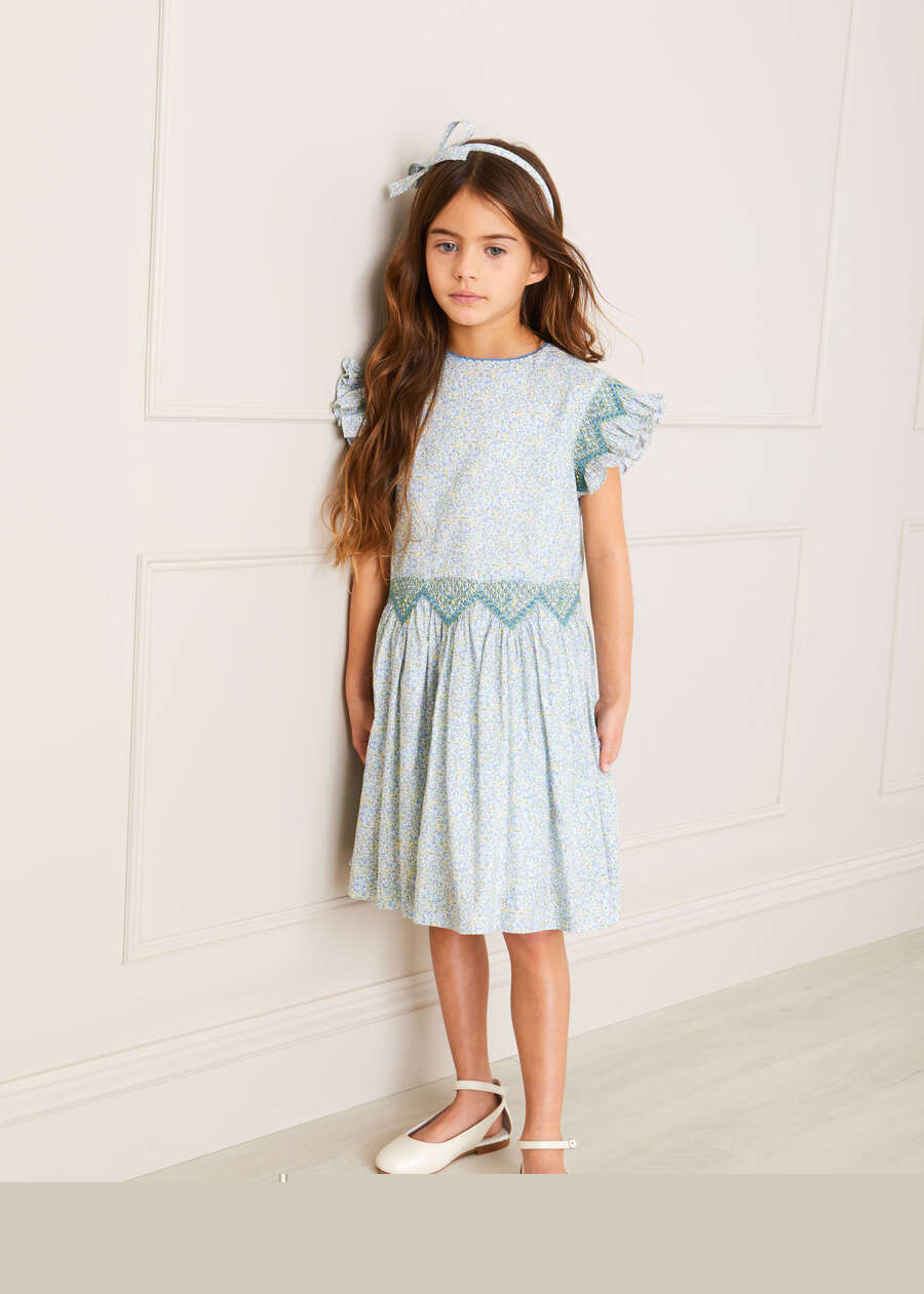 Matilda Floral Print Hand Smocked Sleeveless Dress in Blue (4-10yrs) Dresses  from Pepa London