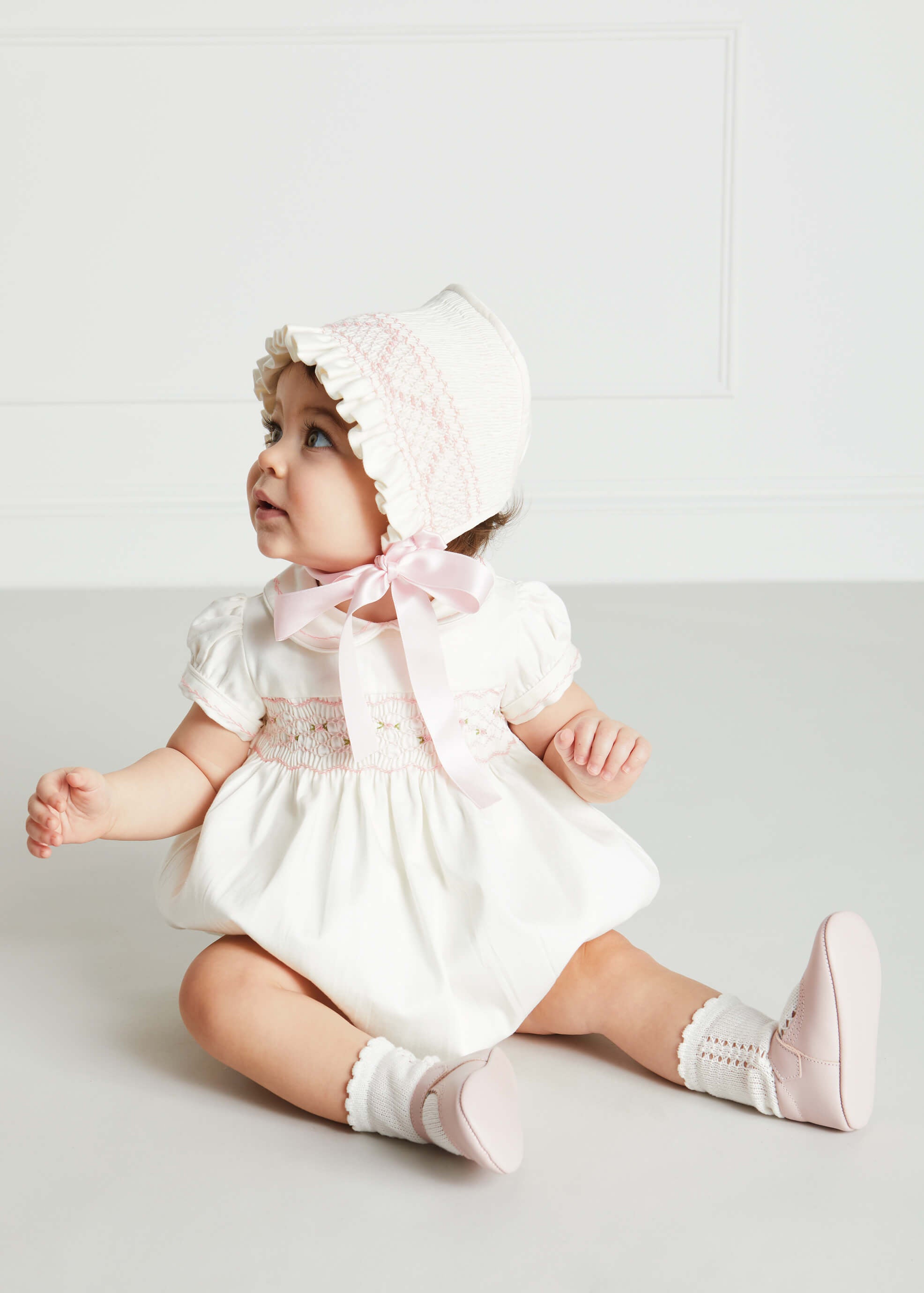 Off White and Pink Hand Smocked Baby Bonnet Knitted Accessories  from Pepa London