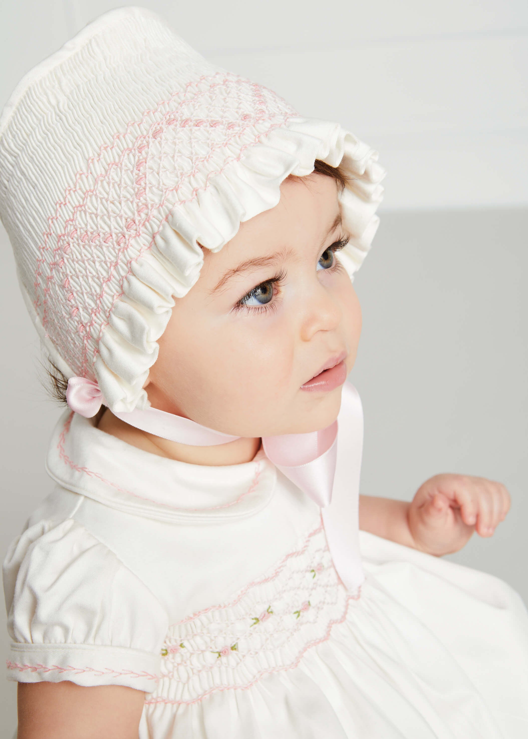 Off White and Pink Hand Smocked Baby Bonnet Knitted Accessories  from Pepa London